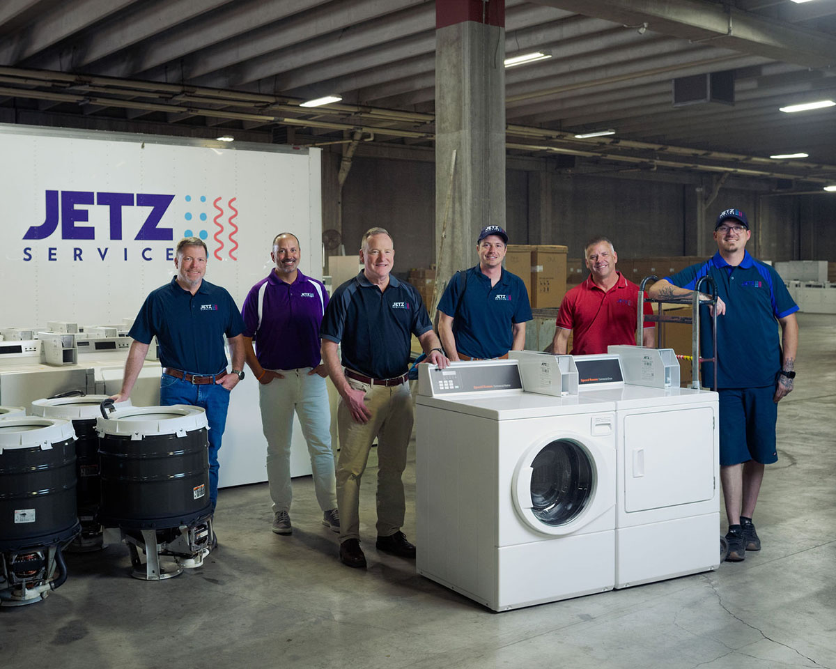 Jetz Service team members standing by a service vehicle